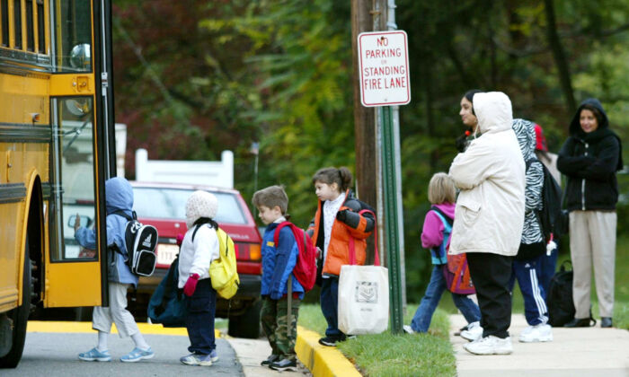 Parents watch as children step onto a Fairfax County school bus at Police headquarters in Falls Church, Virginia, on Oct. 15, 2002.   (Mark Wilson/Getty Images)