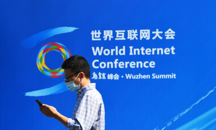 A man walks through the exhibition board of the World Internet Conference in Wuzhen, Zhejiang Province, China, on Sept. 26, 2021. (Lu Hongjie/Future Publishing via Getty Images)