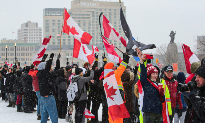 Protesters gather on Parliament Hill on Feb. 12, 2022 during the trucker convoy protests in Ottawa. (Richard Moore/The Epoch Times)