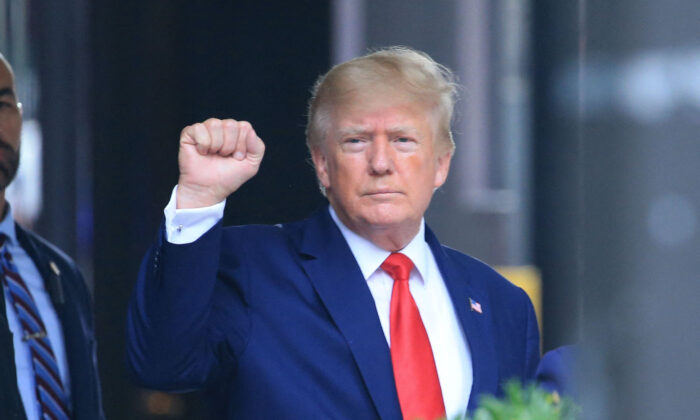 Former President Donald Trump raises his fist while walking to a vehicle outside of Trump Tower in New York on Aug. 10, 2022. (Stringer/AFP via Getty Images)
