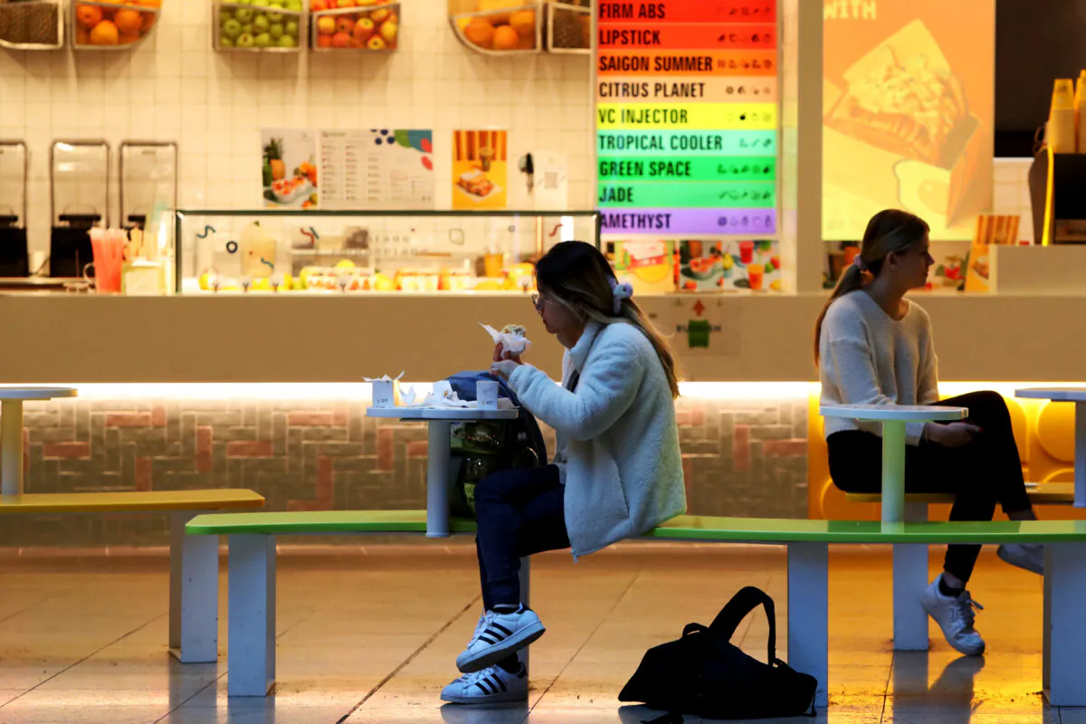 Customers sit outside a food kiosk in the central business district in Sydney, Australia, on Aug. 16, 2022. (Lisa Maree Williams/Getty Images)