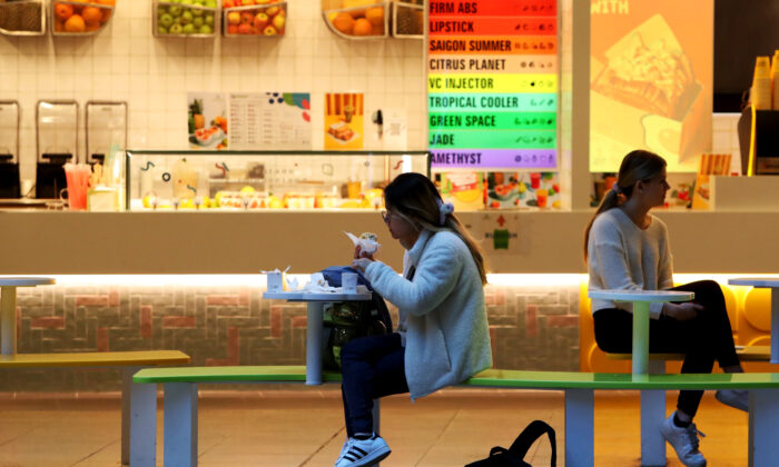 Customers sit outside a food kiosk in the central business district in Sydney, Australia, on Aug. 16, 2022. (Lisa Maree Williams/Getty Images)