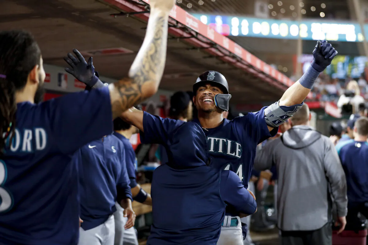 Julio Rodriguez, No. 44 of the Seattle Mariners, celebrates with teammates after hitting a two-run home run against the Los Angeles Angels in the ninth inning at Angel Stadium of Anaheim in Anaheim, on August 16, 2022. (Michael Owens/Getty Images)
