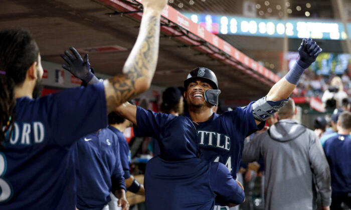 Julio Rodriguez, No. 44 of the Seattle Mariners, celebrates with teammates after hitting a two-run home run against the Los Angeles Angels in the ninth inning at Angel Stadium of Anaheim in Anaheim, on August 16, 2022. (Michael Owens/Getty Images)