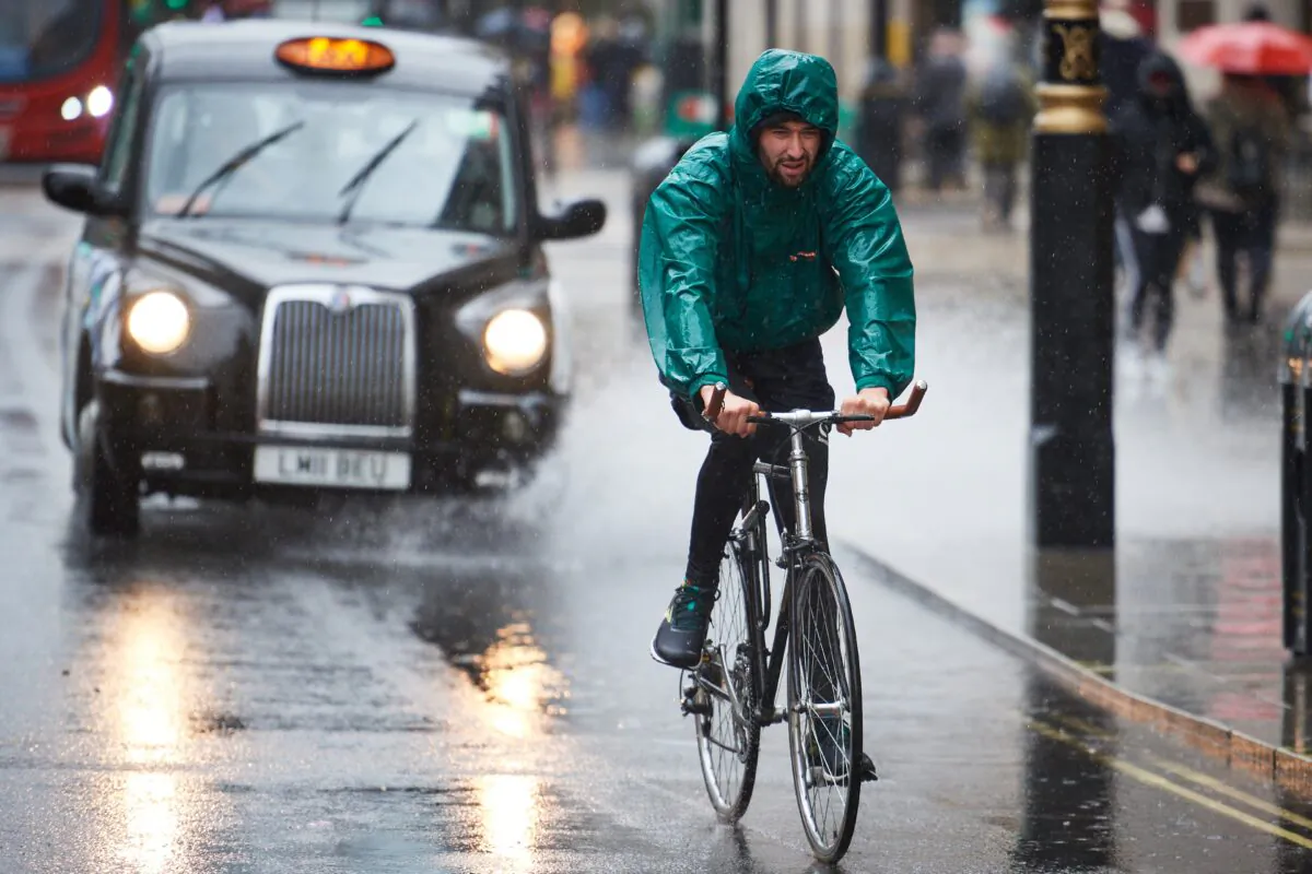 A cyclist rides through a puddle on Oxford Street, London, on Oct. 2, 2020. (Leon Neal/Getty Images)