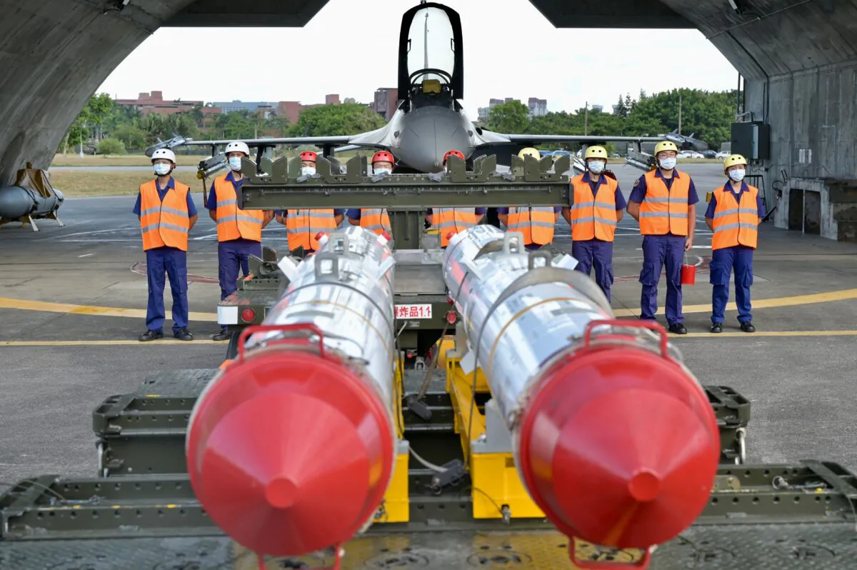 Air Force soldiers stand in front of an armed F-16V fighter jet behind two U.S. made Harpoon AGM-84 anti ship missiles during a drill at Hualien Air Force base in Hualien County, Taiwan, on Aug. 17, 2022. (Sam Yeh/AFP via Getty Images)