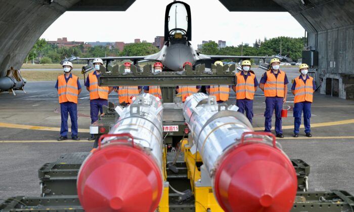 Air Force airmen stand in front of an armed F-16V fighter jet behind two U.S.-made Harpoon AGM-84 anti-ship missiles during a drill at Hualien Air Force base in Hualien County, Taiwan, on Aug. 17, 2022. (Sam Yeh/AFP via Getty Images)