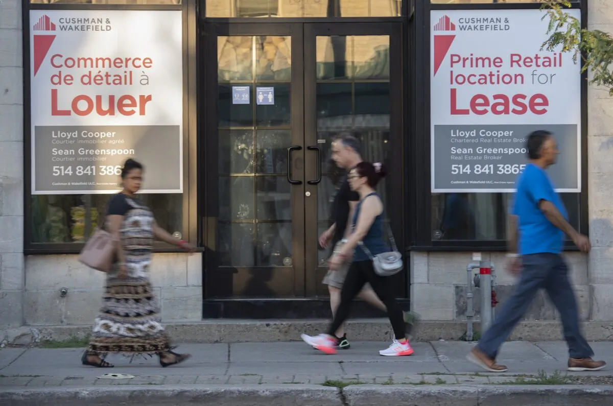 People walk by bilingual signs for a commercial space for lease in the city of Westmount on the island of Montreal on Aug. 5, 2022. (The Canadian Press/Graham Hughes)
