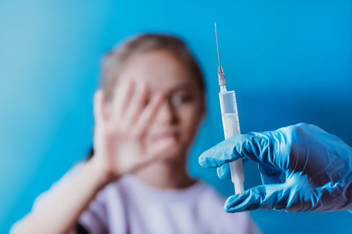 A child refuses to be vaccinated. (Nataliia Maksymenko/Shutterstock)