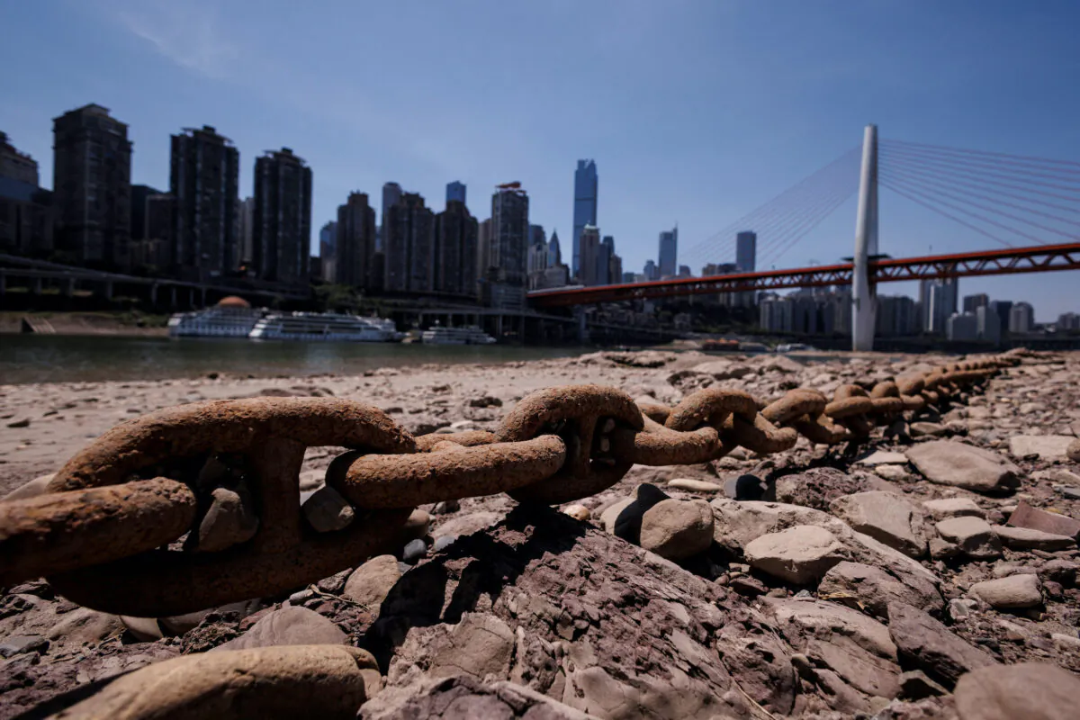 A chain that holds a boat jetty lies exposed on the dried-up riverbed of the Jialing river, a tributary of the Yangtze, that is approaching record-low water levels in Chongqing, China, on Aug. 18, 2022. (Thomas Peter/Reuters)