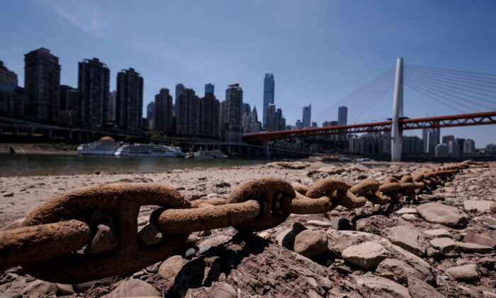 A chain that holds a boat jetty lies exposed on the dried-up riverbed of the Jialing river, a tributary of the Yangtze, that is approaching record-low water levels in Chongqing, China, on Aug. 18, 2022. (Thomas Peter/Reuters)