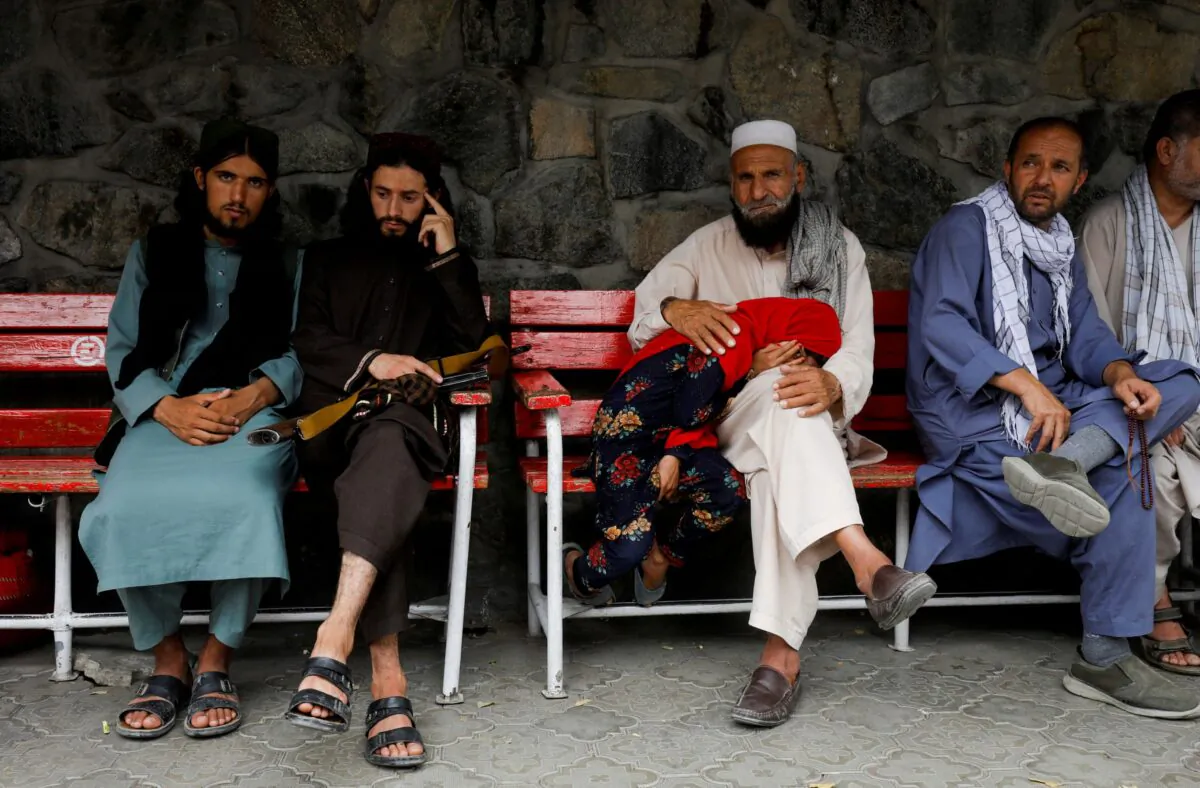 Families of victims from the previous night's explosion wait in front of an emergency hospital in Kabul, Afghanistan, on Aug. 18, 2022. (Ali Khara/Reuters)