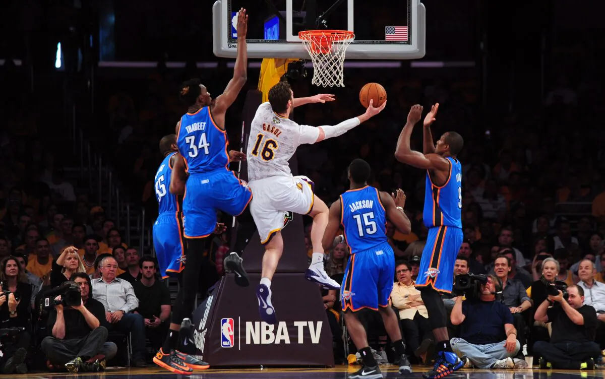 Pau Gasol of the Los Angeles Lakers (No. 16) drives to the hoop under pressure from Kevin Durant (No. 34), Hasheem Thabeet (No. 34), Reggie Jackson (No. 15) and Serge Ibaka (R) of the Oklahoma City Thunder during their NBA matchup at Staples Center in Los Angeles on March 9, 2014. (Frederic J. Brown/AFP via Getty Images)