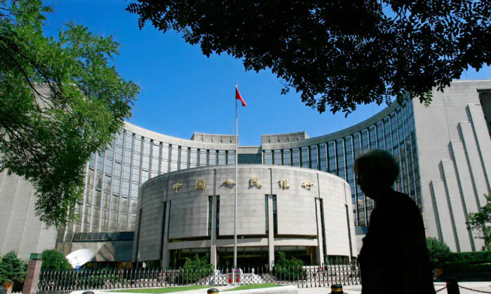 A pedestrian walks past the People's Bank of China, also known as the China's Central Bank, in central Beijing. (Teh Eng Koon/AFP via Getty Images)