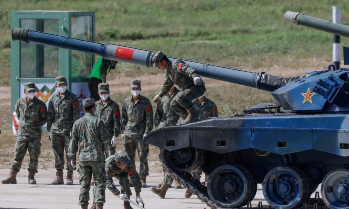 Chinese soldiers operate with their Type 96A tank during the Tank Biathlon competition at the International Army Games 2022 in Alabino, outside Moscow, Russia, on Aug. 16, 2022. Moscow announced its plans to hold joint military exercises with China, India, Mongolia, Belarus, and Tajikistan from Aug. 30 to Sept. 5, 2022. (Maxim Shemetov/Reuters)