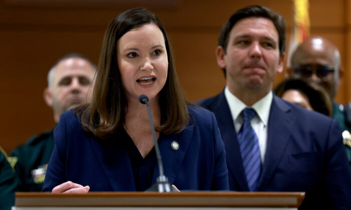 Florida Gov. Ron DeSantis listens as Florida Attorney General Ashley Moody speaks during a press conference at the Broward County Courthouse in Fort Lauderdale, Fla., on Aug. 18, 2022. (Joe Raedle/Getty Images)