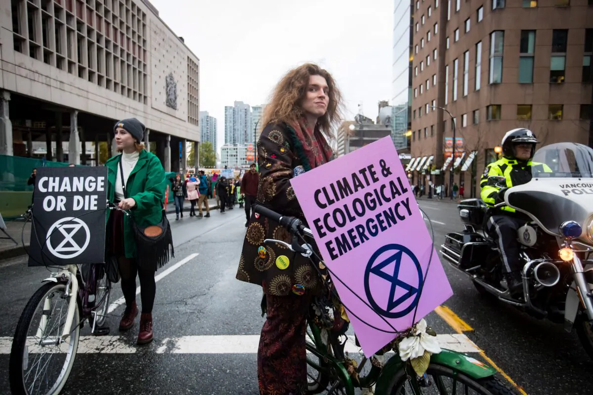 Activists block traffic during a climate change protest in downtown Vancouver on Oct. 18, 2019. (The Canadian Press/Darryl Dyck)