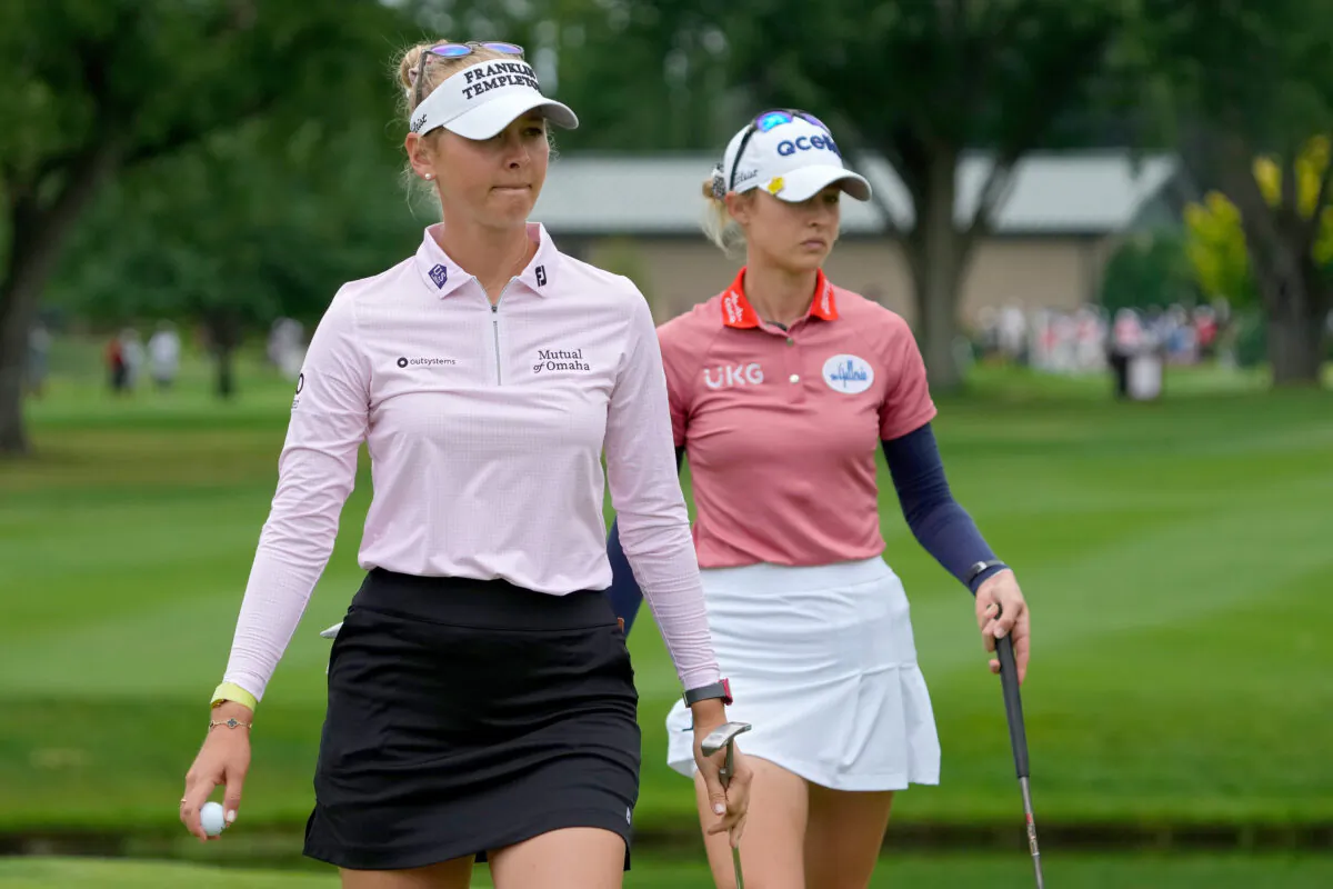 Jessica Korda of the United States (L) and Nelly Korda of the United States walk across the fifth green during the final round of the Dow Great Lakes Bay Invitational at Midland Country Club in Midland, Mich., July 16, 2022. (Dylan Buell/Getty Images)