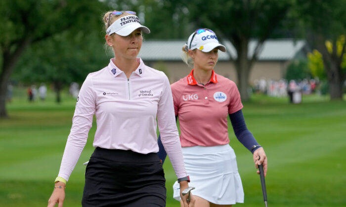 Jessica Korda of the United States (L) and Nelly Korda of the United States walk across the fifth green during the final round of the Dow Great Lakes Bay Invitational at Midland Country Club in Midland, Mich., July 16, 2022. (Dylan Buell/Getty Images)