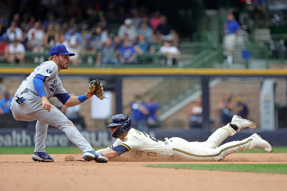 Mike Brosseau #20 of the Milwaukee Brewers beats a tag by Gavin Lux #9 of the Los Angeles Dodgers during the fifth inning to steal second base at American Family Field in Milwaukee, August 18, 2022. (Stacy Revere/Getty Images)
