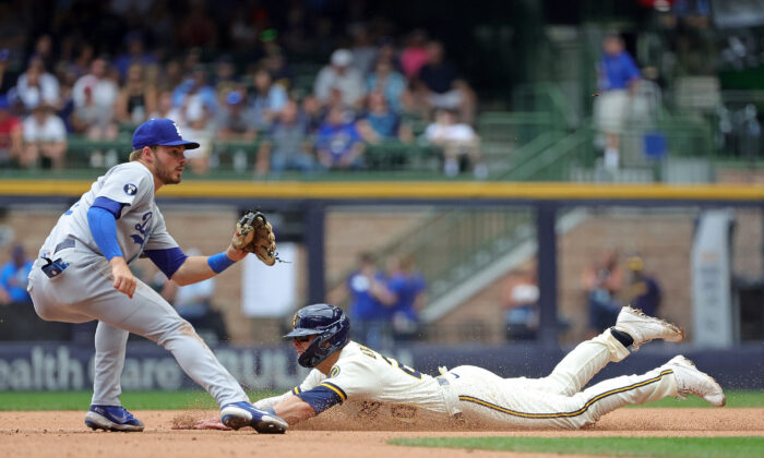 Mike Brosseau #20 of the Milwaukee Brewers beats a tag by Gavin Lux #9 of the Los Angeles Dodgers during the fifth inning to steal second base at American Family Field in Milwaukee, August 18, 2022. (Stacy Revere/Getty Images)