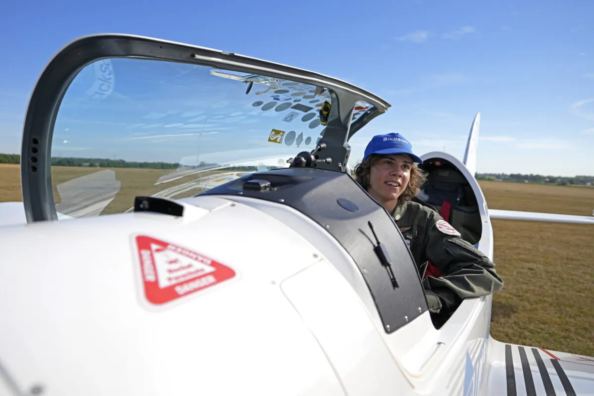 Anglo-Belgian pilot, Mack Rutherford, 17, speaks with the media after landing at the Buzet airfield in Pont-A-Celles, Belgium, on Aug. 23, 2022. (Virginia Mayo/AP Photo)