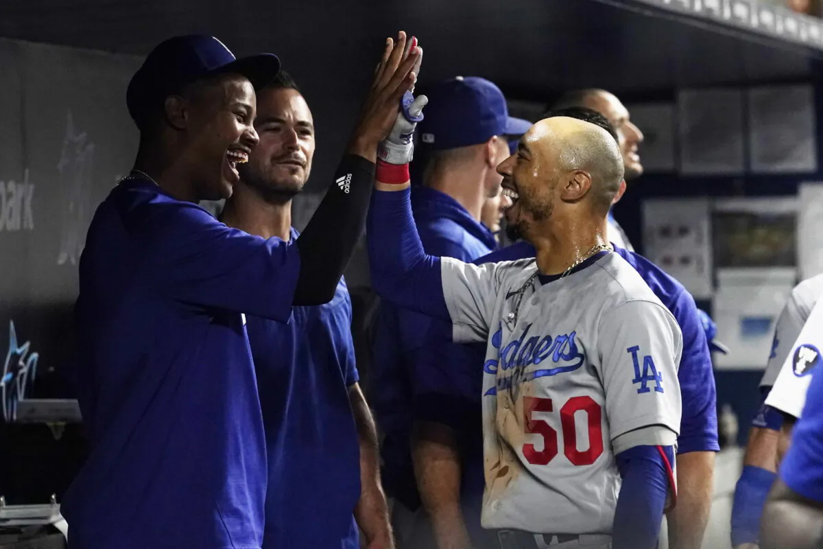 Los Angeles Dodgers' Mookie Betts (50) is congratulated by a teammate after scoring a two-run home run in the seventh inning of a baseball game against the Miami Marlins in Miami, Aug. 26, 2022. (Marta Lavandier/AP Photo)