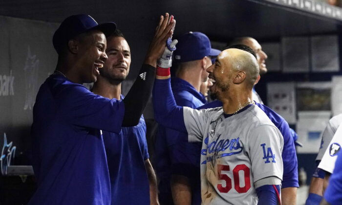 Los Angeles Dodgers' Mookie Betts (50) is congratulated by a teammate after scoring a two-run home run in the seventh inning of a baseball game against the Miami Marlins in Miami, Aug. 26, 2022. (Marta Lavandier/AP Photo)