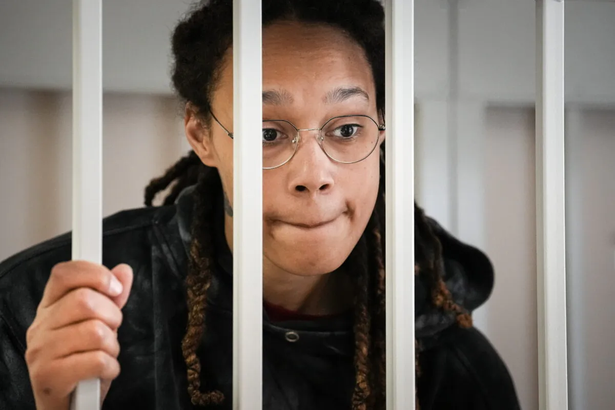 WNBA star and two-time Olympic gold medalist Brittney Griner speaks to her lawyers standing in a cage at a court room prior to a hearing, in Khimki just outside Moscow on July 26, 2022. (Alexander Zemlianichenko/AP Photo, Pool)