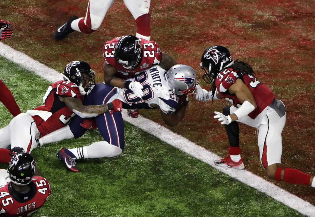 New England Patriots' James White scores the winning touchdown during overtime of the NFL Super Bowl 51 football game against the Atlanta Falcons in Houston, Sunday, Feb. 5, 2017. James White said Thursday, Aug. 11, 2022, he is retiring from the NFL. (Charlie Riedel/AP Photo)