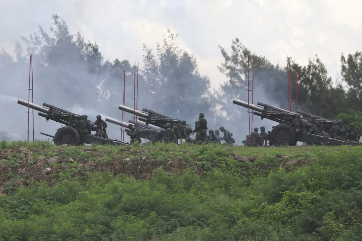 Soldiers fire 155mm howitzers during an annual live fire military exercise in Pingtung County, Taiwan, on Aug. 9, 2022. (Ann Wang/Reuters)