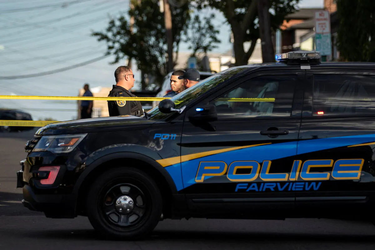 New Jersey Police officers stand guard near the building where alleged attacker of Salman Rushdie, Hadi Matar, lives in Fairview, N.J., on Aug. 12, 2022. (Eduardo Munoz/Reuters)