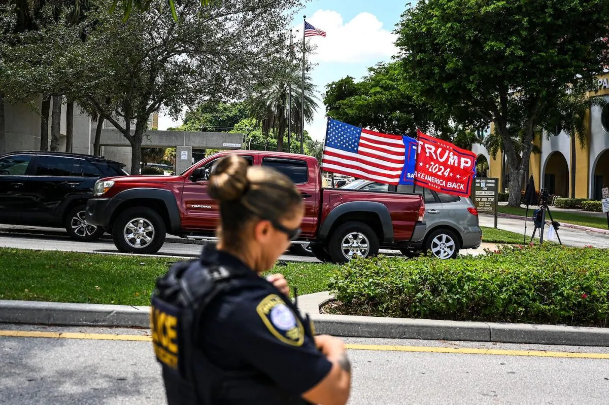 Supporters of former U.S. President Donald Trump in West Palm Beach, Fla. drive around the Paul G. Rogers Federal Building & Courthouse on Aug. 18, 2022, as the court holds a hearing to determine if the affidavit used by the FBI as justification for the raid of Trump's Mar-a-Lago estate should be unsealed. (Chandan Khanna/AFP via Getty Images)