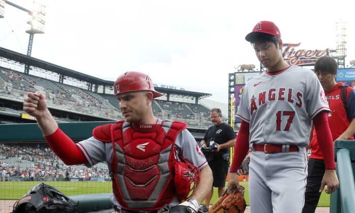 Shohei Ohtani #17 and catcher Max Stassi #33 of the Los Angeles Angels walk into the dugout before a game against the Detroit Tigers at Comerica Park in Detroit, on August 21, 2022. (Duane Burleson/Getty Images)