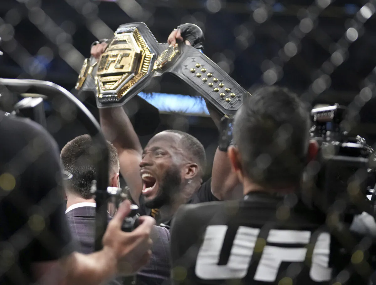 UFC fighter Leon Edwards of Jamaica celebrates his title as welterweight champion of the world after knocking out Nigerian UFC fighter Kamaru Usman during the UFC 278 mixed martial arts title bout in Salt Lake City on Aug. 20, 2022. (Francisco Kjolseth/The Salt Lake Tribune via AP)