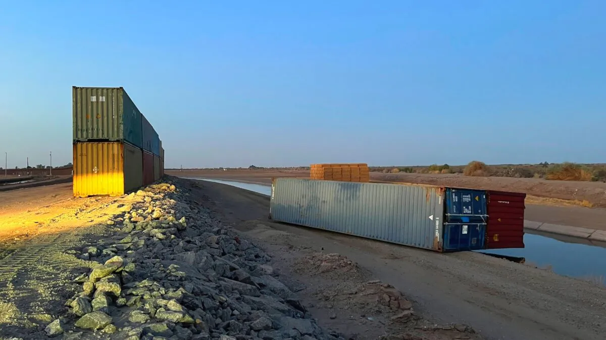 This photo provided of Univision Arizona shows empty shipping containers toppled over on the Mexico-U.S. international borderline in Yuma, Ariz., on Aug. 16, 2022. (Claudia Ramos/Univision Arizona via AP)