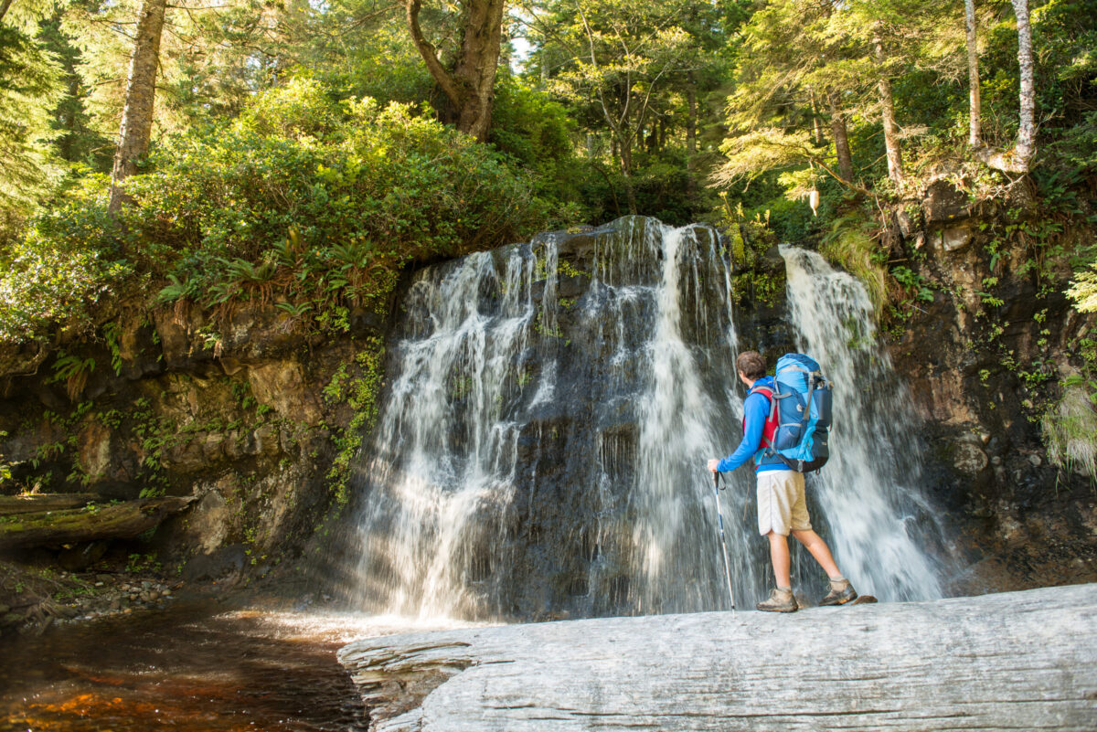 A hiker marvels at the picturesque waterfall at Bonilla Creek
