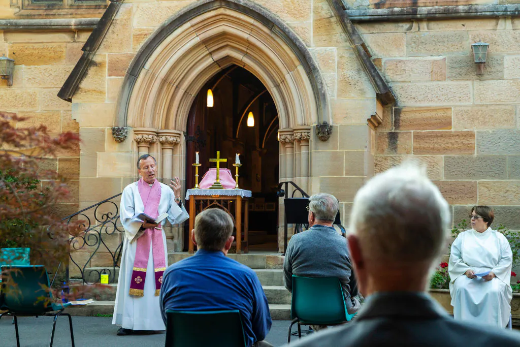 Father James Collins holds a service in the yard of St Paul's Anglican Church in Burwood with seating observant of social distancing in Sydney, Australia, on March 22, 2020. (Jenny Evans/Getty Images)