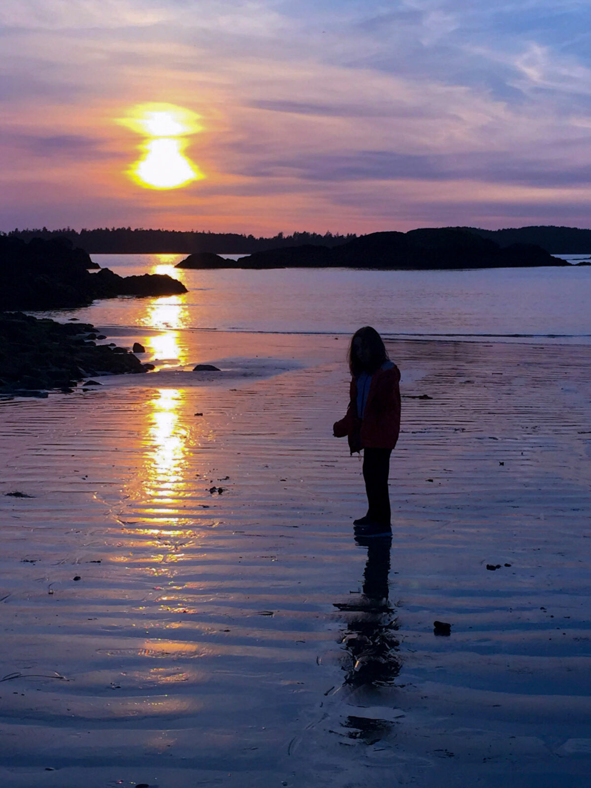 Tofino, the beach at sunset with a silhouette of our daughter.