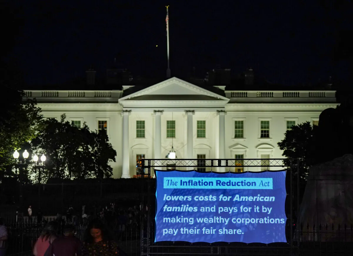 A projection displays information about the Inflation Reduction Act in front of the White House in Washington on Aug. 12, 2022. (Jemal Countess/Getty Images for DNC)