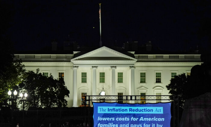 A projection displays information about the Inflation Reduction Act in front of the White House in Washington on Aug. 12, 2022. (Jemal Countess/Getty Images for DNC)