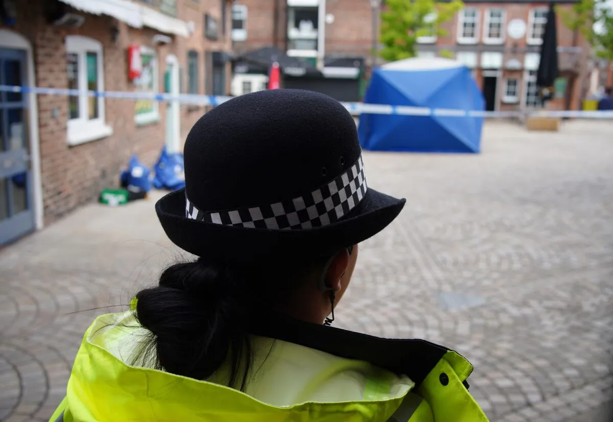 A police officer guards the scene where Rico Burton, cousin of heavyweight boxing champion Tyson Fury, was stabbed, in Altrincham, Greater Manchester, UK, on Aug. 22, 2022. (PA)