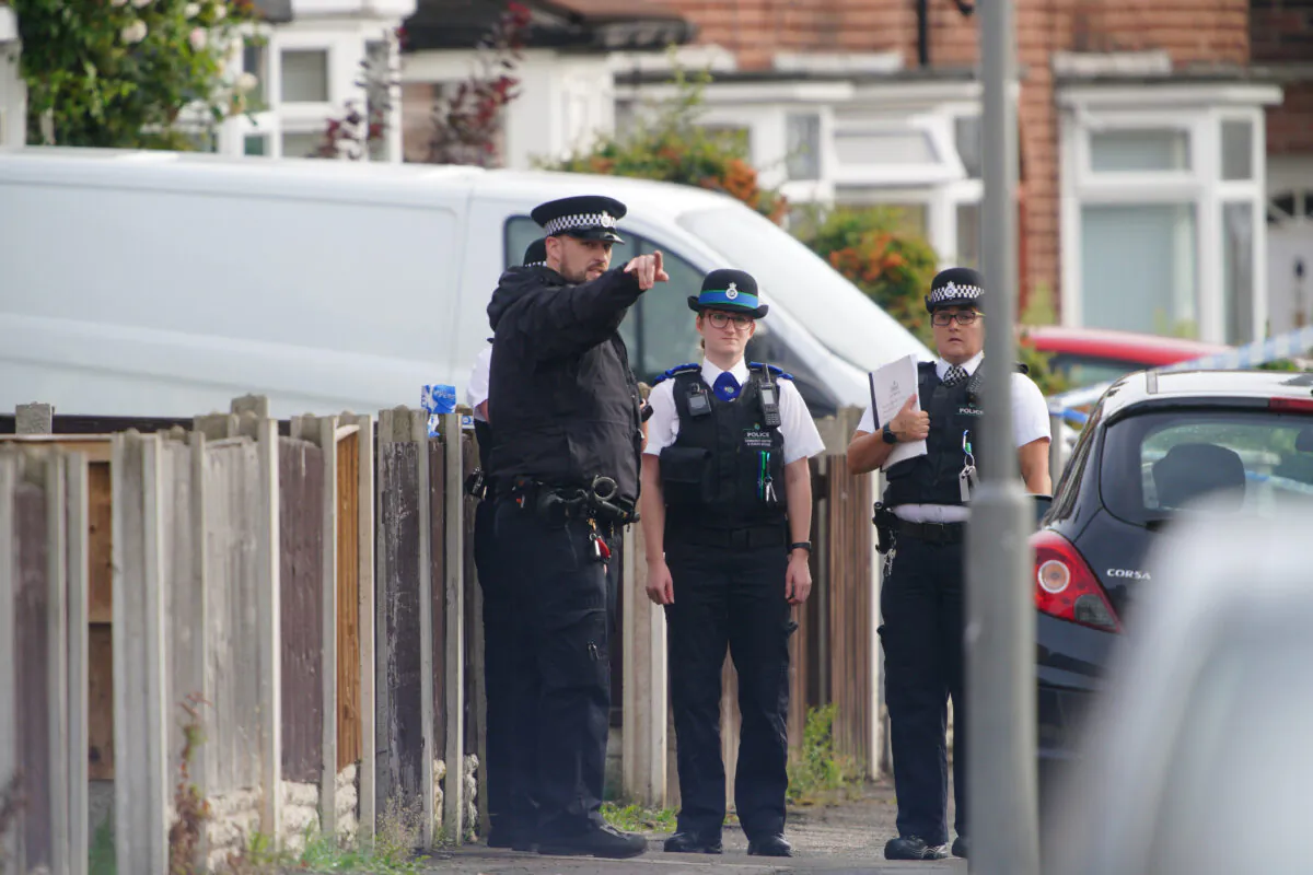 Police officers at the scene where a 9-year-old girl was shot dead in Knotty Ash, Liverpool, United Kingdom, on Aug. 23, 2022. (PA)