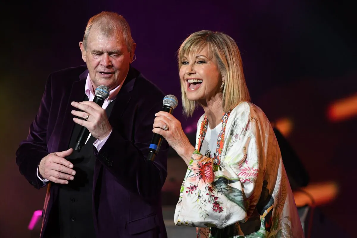 John Farnham (L) and Olivia Newton-John (R) perform during the Fire Fight Australia bushfire relief concert at ANZ Stadium in Sydney, Sunday, February 16, 2020. (AAP Image/Joel Carrett)
