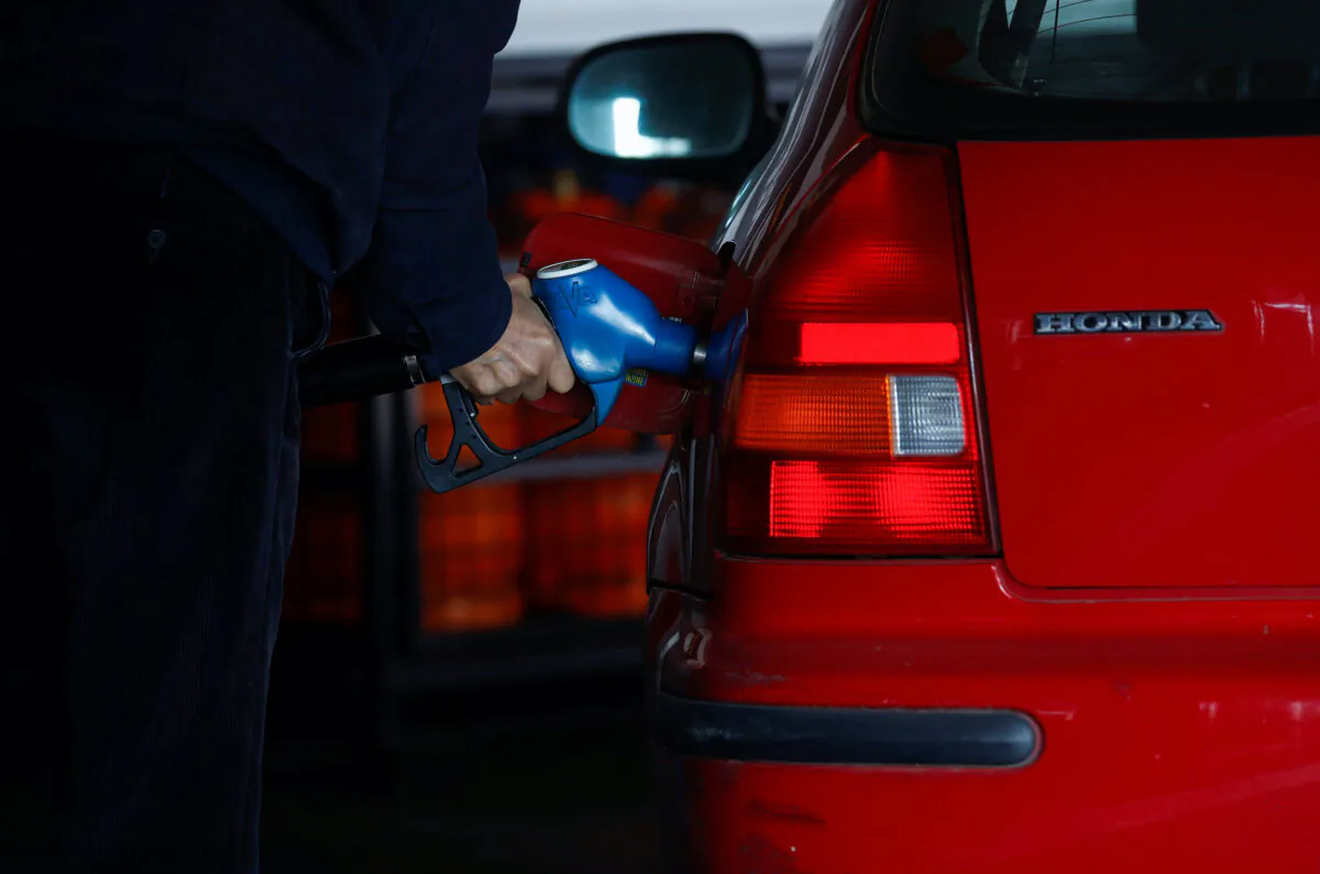 A man fills fuel at a service station during a significant increase in the price of energy in Madrid, on March 8, 2022. (Juan Medina/Reuters)