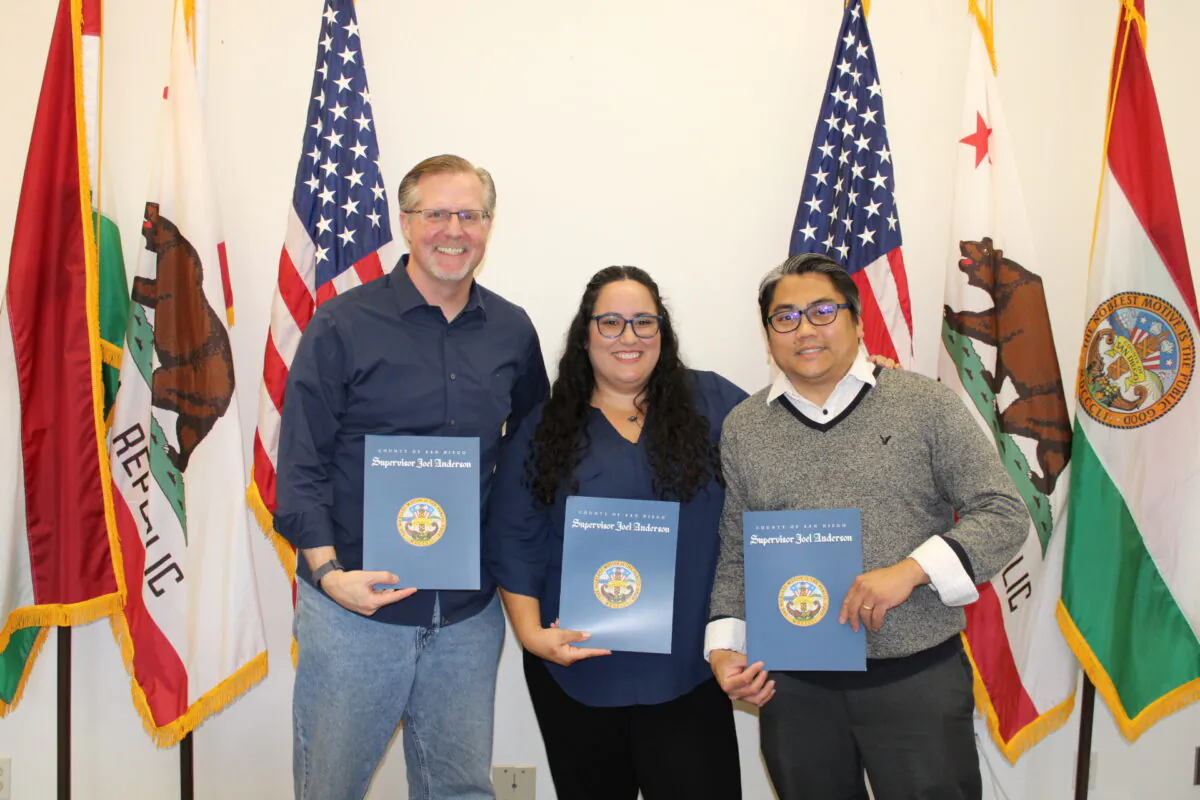 (L-R) Angels Executive Director Jeff Weimann and resource parents Rae’ah and Max Maningas receive recognition from Supervisor Joel Anderson in San Diego. (Courtesy of San Diego Supervisor Joel Anderson’s office).