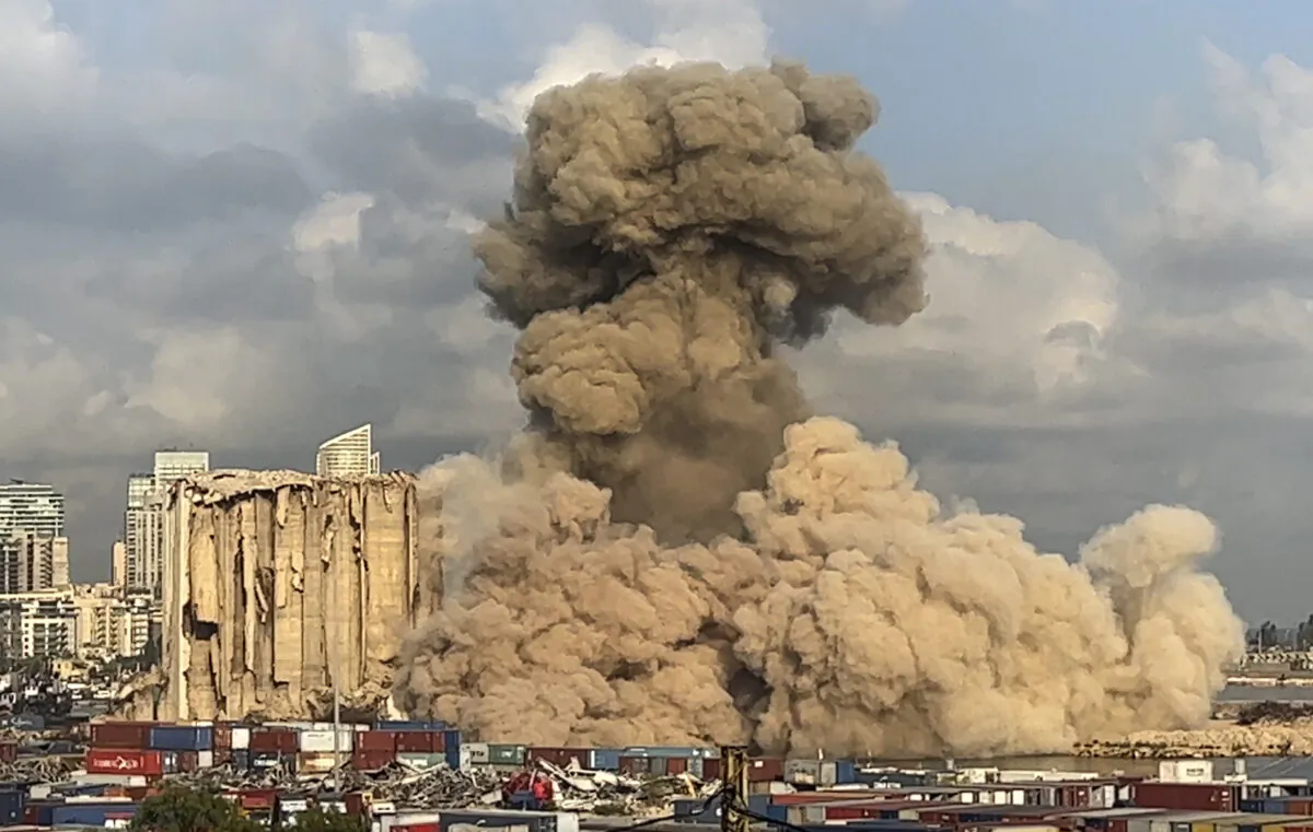 This still image from a video shows smoke and dust rising from collapsing silos damaged during the massive explosion in the port of Beirut, on Aug. 23, 2022. (Lujain Jo/AP Photo)