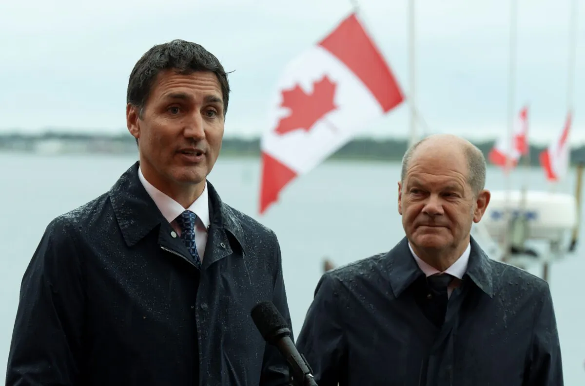 German Chancellor Olaf Scholz (R) looks on as Prime Minister Justin Trudeau responds to a question during a joint media availability in Stephenville, Newfoundland and Labrador, on Aug. 23, 2022. (The Canadian Press/Adrian Wyld)