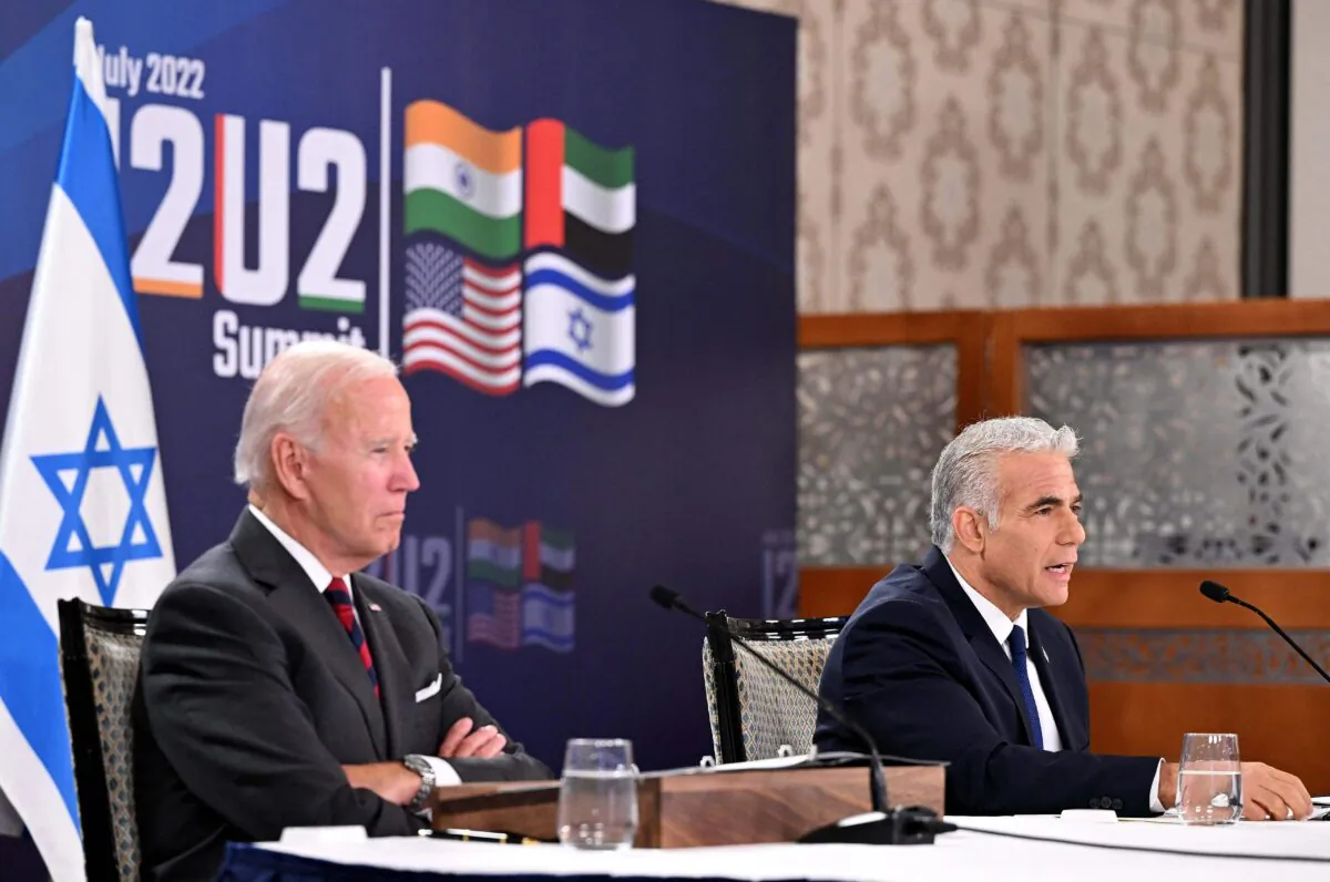 US President Joe Biden (L) and Israel's Prime Minister Yair Lapid, take part in a virtual meeting with leaders of the I2U2 group, which includes, US, Israel, India, and the United Arab Emirates, at a hotel in Jerusalem, on July 14, 2022. (MANDEL NGAN/AFP via Getty Images)
