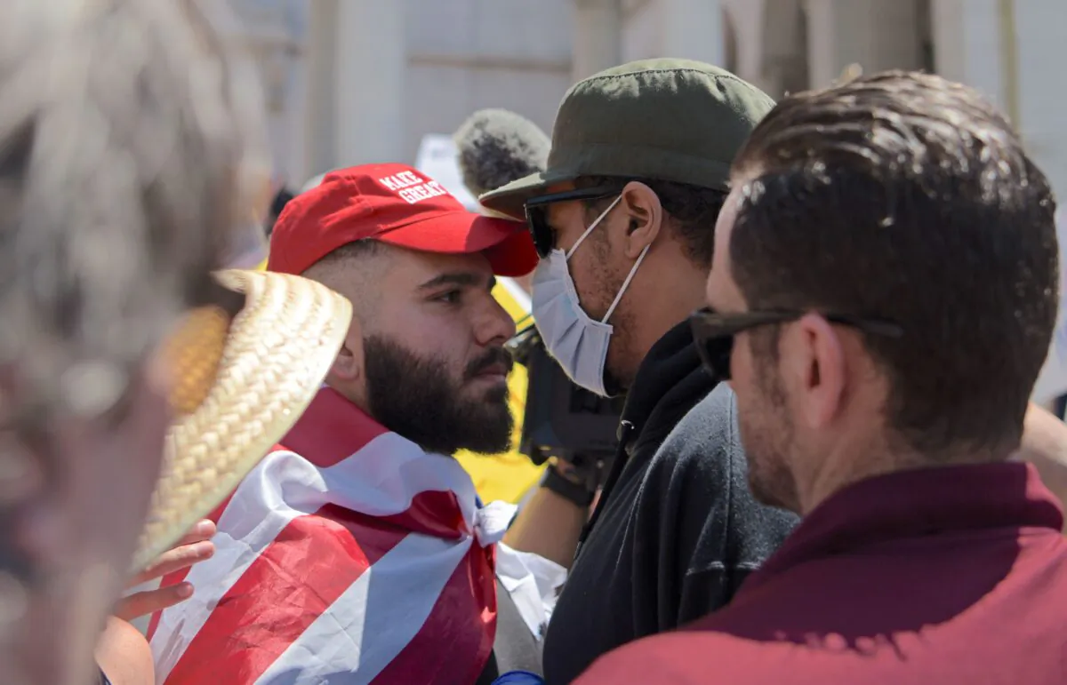 Protestors and counter-protestors clash during a demonstration against stay-at-home orders near Los Angeles City Hall on May 1, 2020. (Agustin Paullier/AFP via Getty Images)